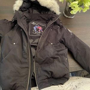 This is a medium kids girls black Moose Knuckle winter jacket bomber style.